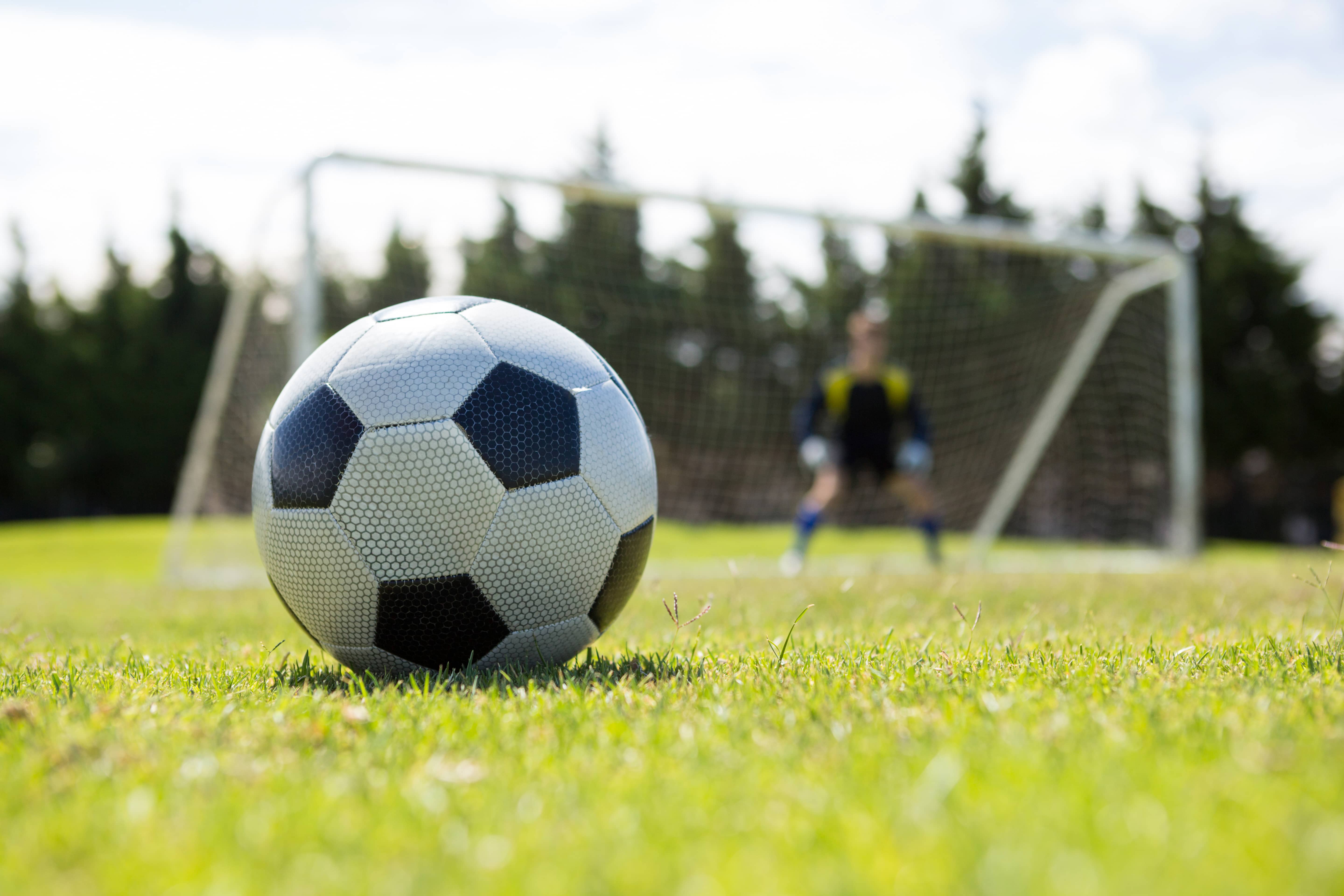 close-up-of-soccer-ball-on-field-against-goalkeeper