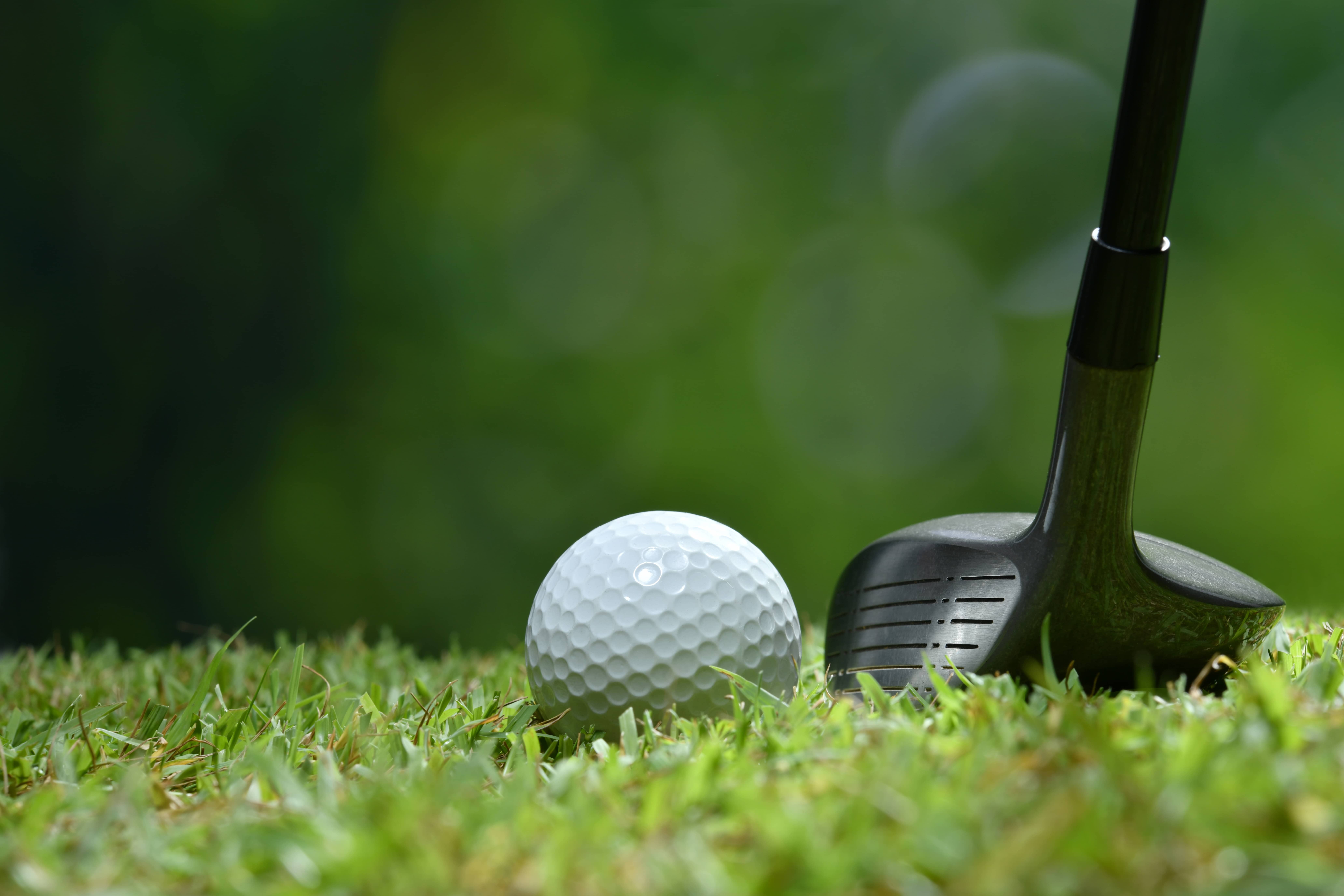 golf-ball-on-green-grass-ready-to-be-struck-on-golf-course-background