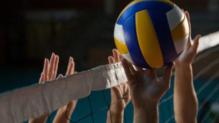 cropped-hands-of-players-practicing-volleyball-at-court-2