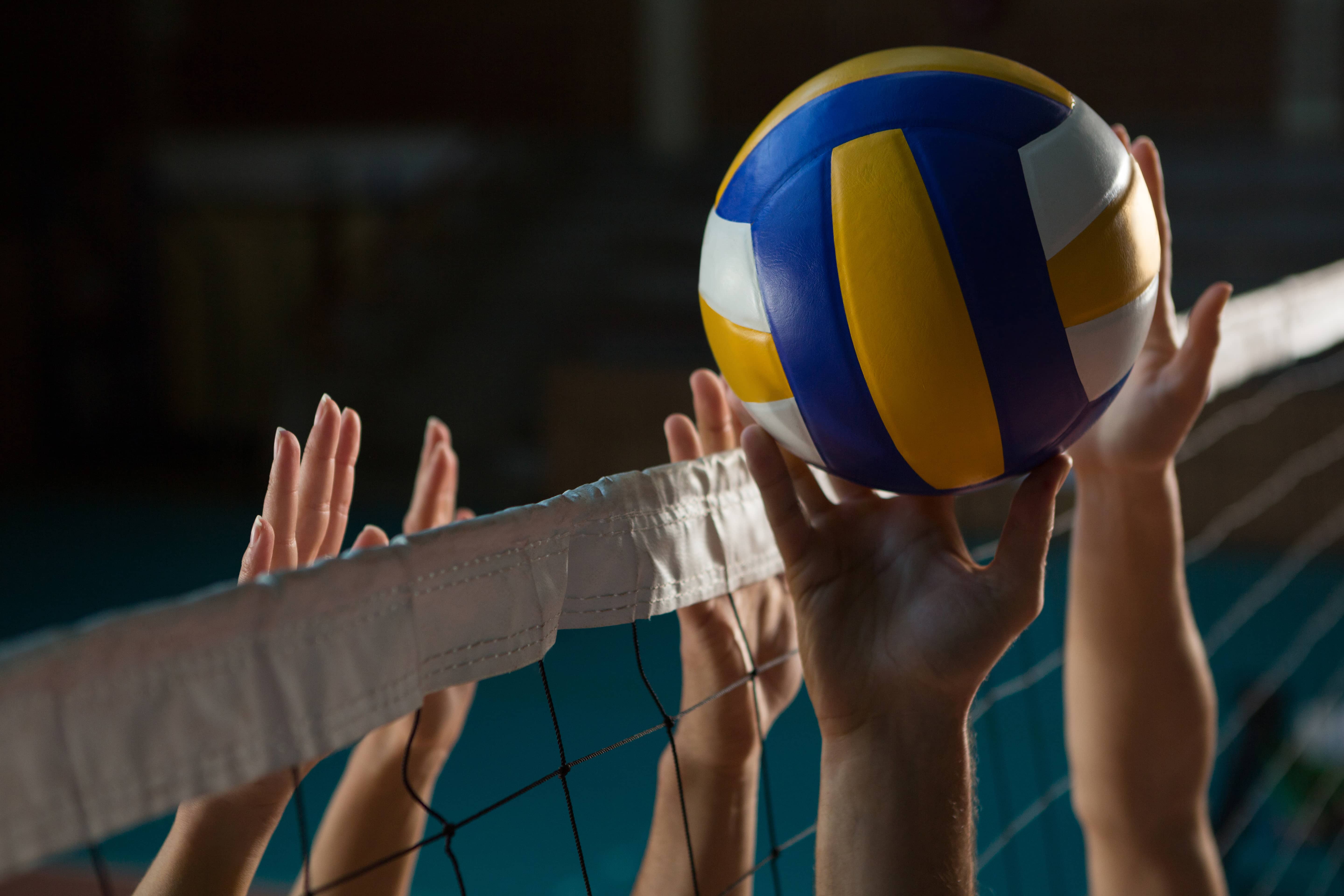 cropped-hands-of-players-practicing-volleyball-at-court-2
