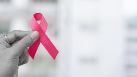 october-breast-cancer-awareness-month-woman-holding-pink-ribbon