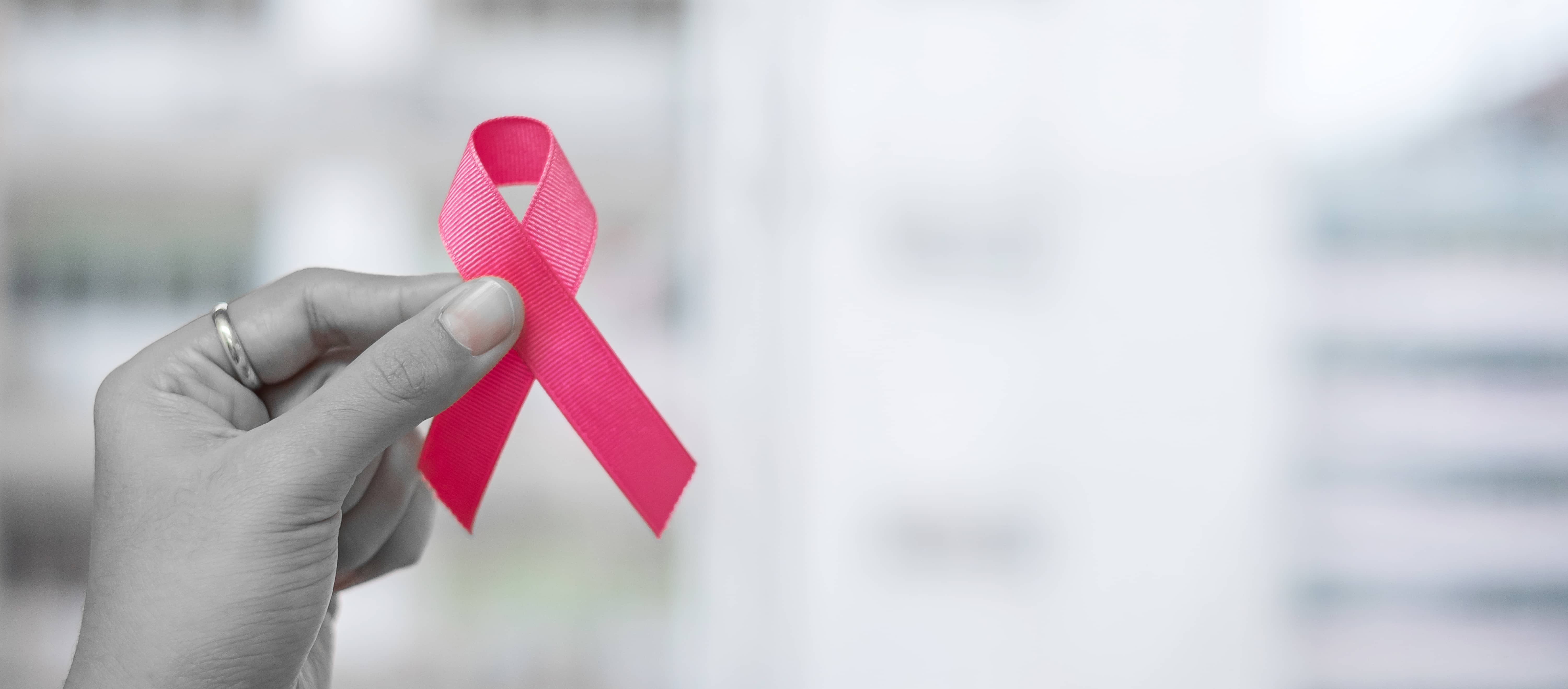 october-breast-cancer-awareness-month-woman-holding-pink-ribbon