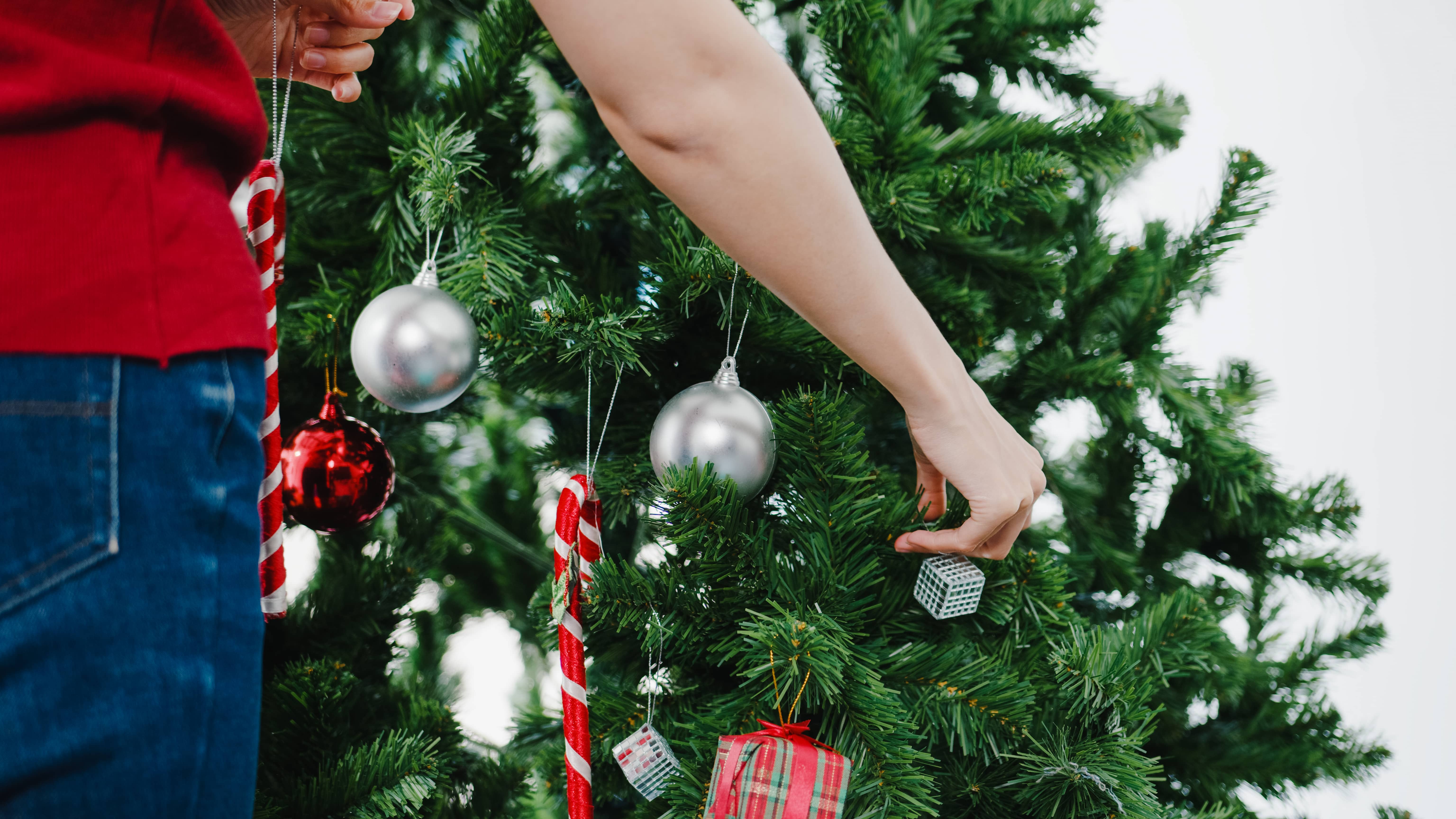 asian-female-decorated-with-ornament-on-christmas-tree-at-christ