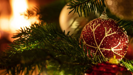 christmas-tree-close-up-on-blur-glowing-fire-background