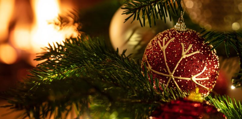 christmas-tree-close-up-on-blur-glowing-fire-background