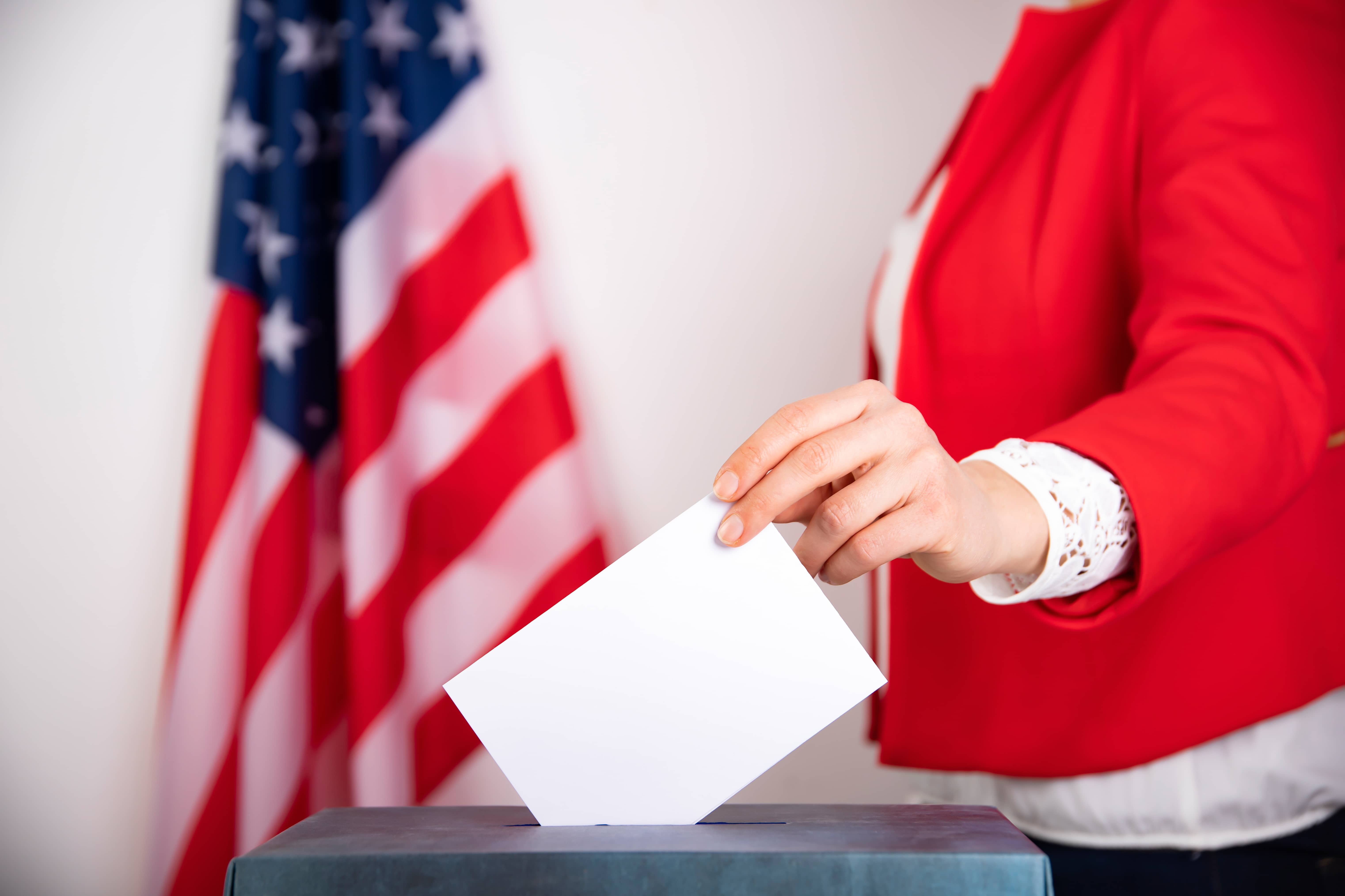american-voter-putting-ballot-into-voting-box