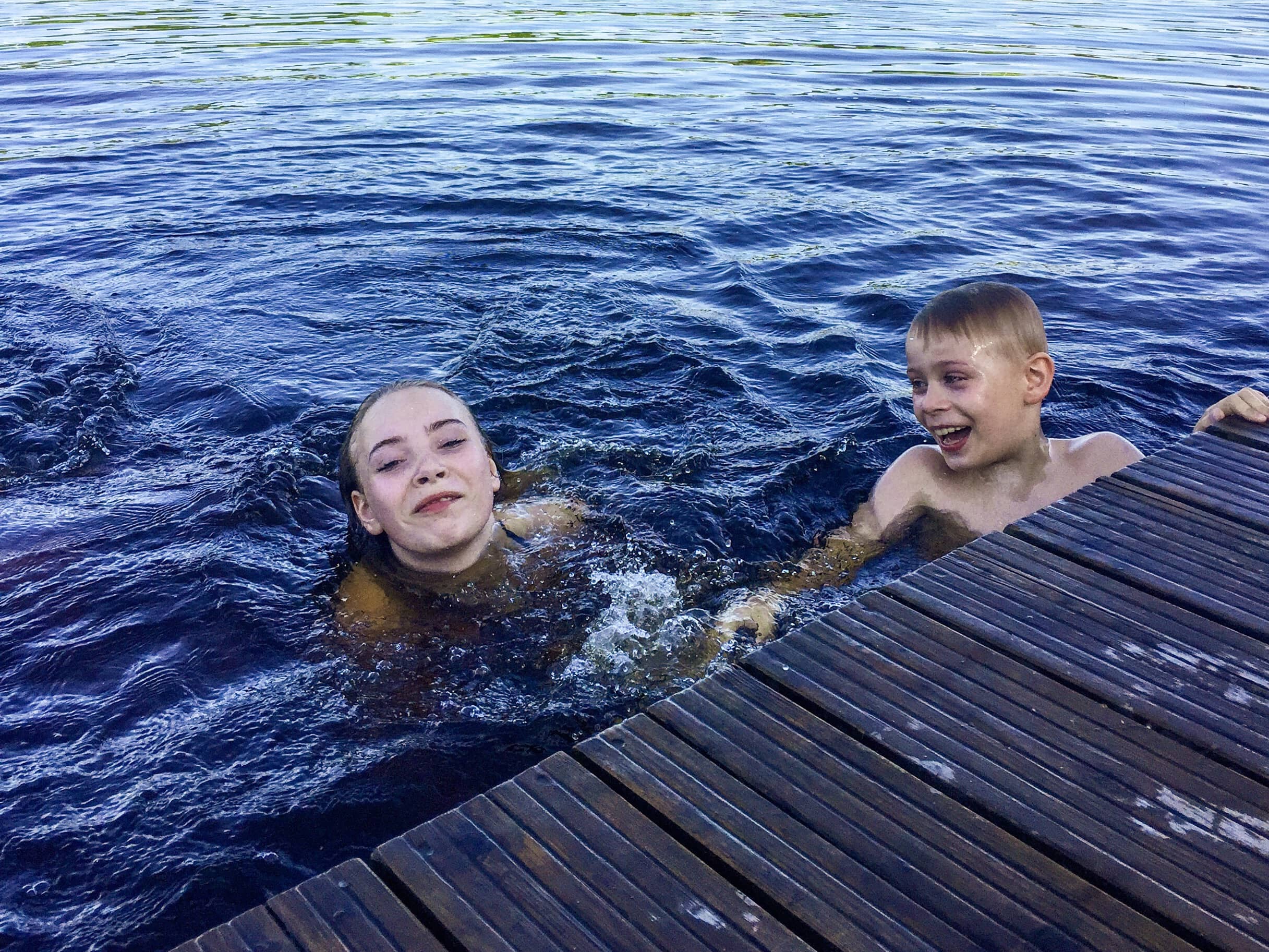 two-happy-siblings-swimming-in-the-lake-2021-08-29-20-19-00-utc