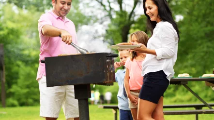 dad-dishing-out-cooked-food-at-family-cookout