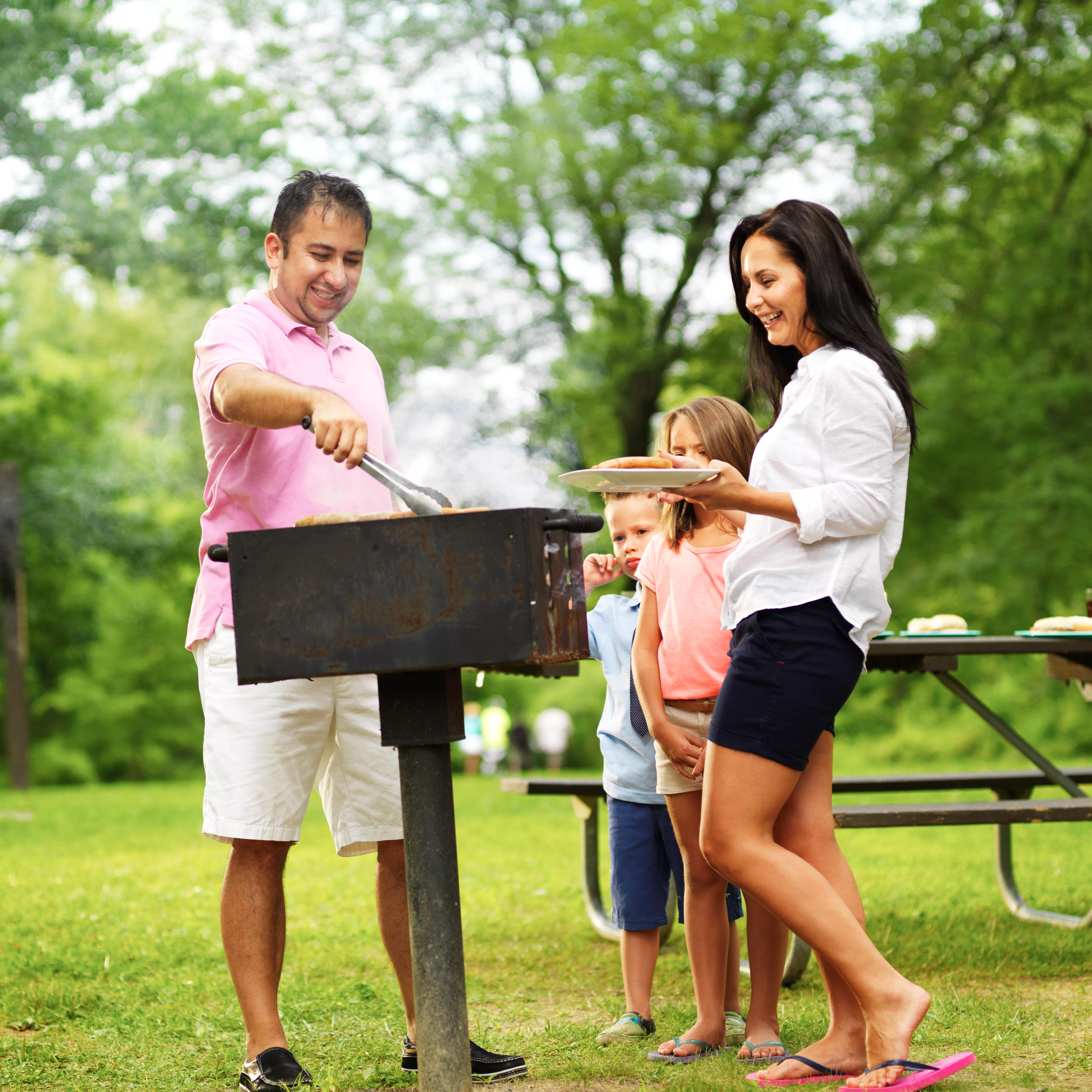 dad-dishing-out-cooked-food-at-family-cookout