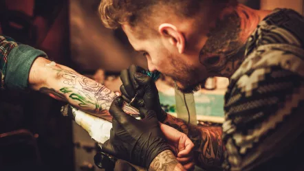 tattoo-artist-makes-a-tattoo-on-a-mans-hand