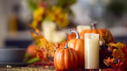 autumn-or-fall-table-decoration-at-home-with-pumpkins-candle-and-leaves