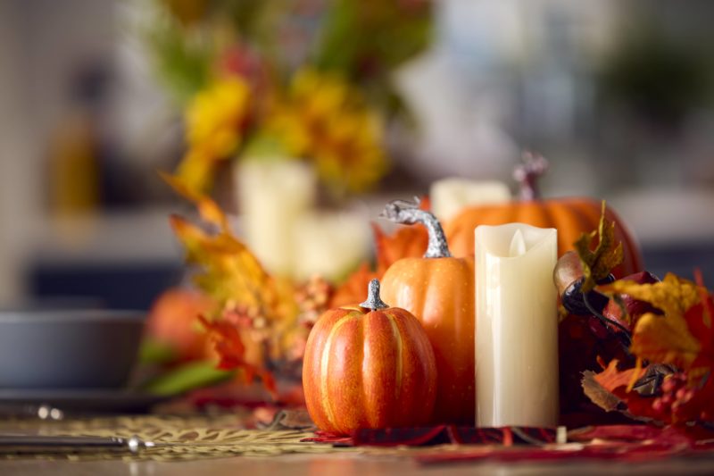 autumn-or-fall-table-decoration-at-home-with-pumpkins-candle-and-leaves