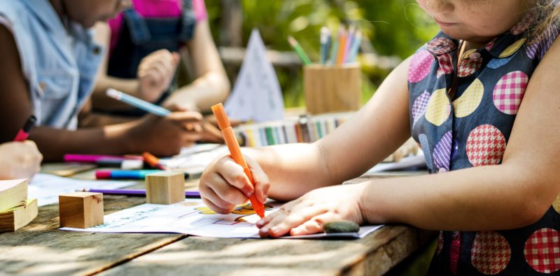 group-of-kindergarten-kids-friends-drawing-art-class-outdoors