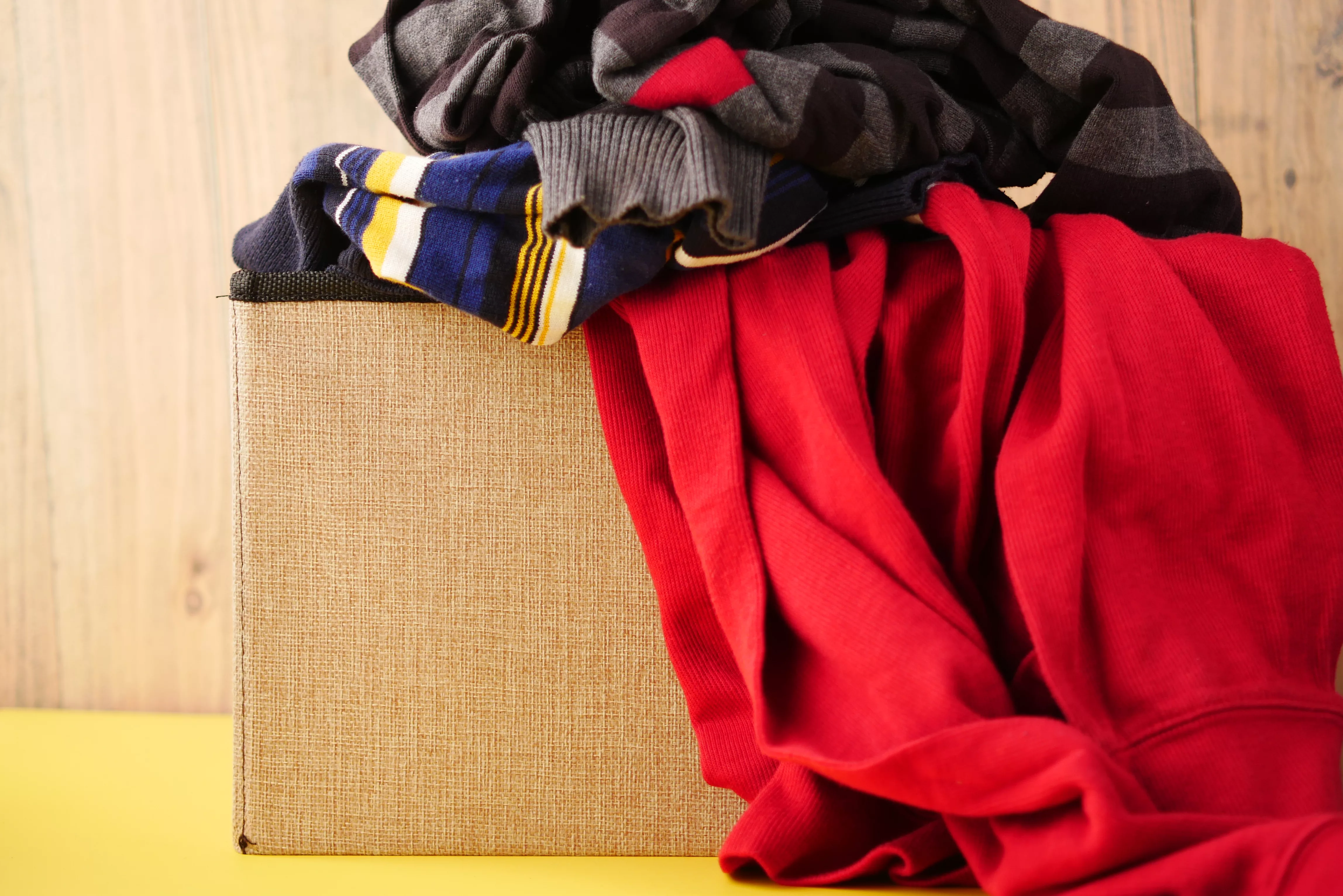 donation-box-with-donation-clothes-on-a-wooden-table
