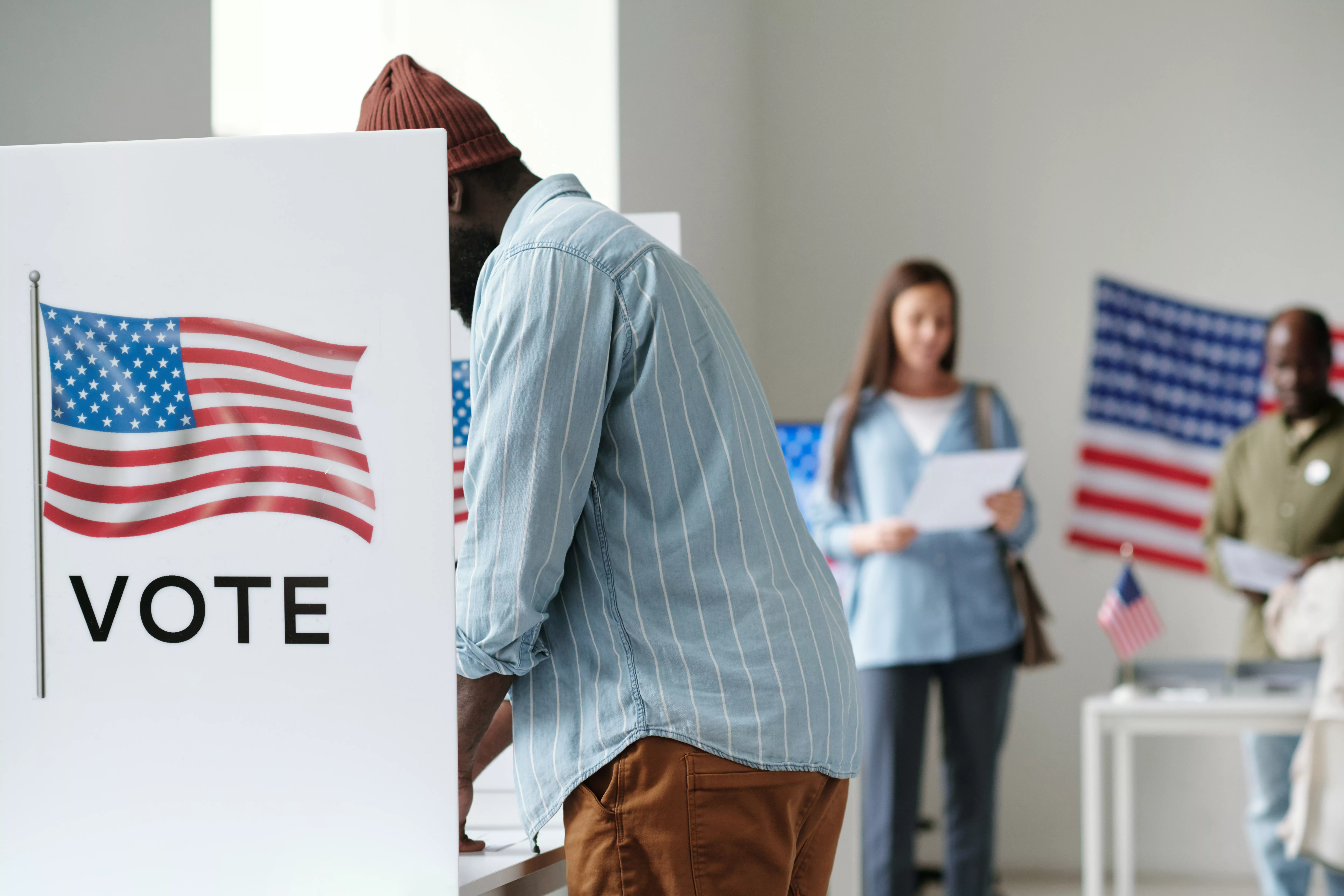 side-view-of-young-african-american-male-voter-filling-in-ballot