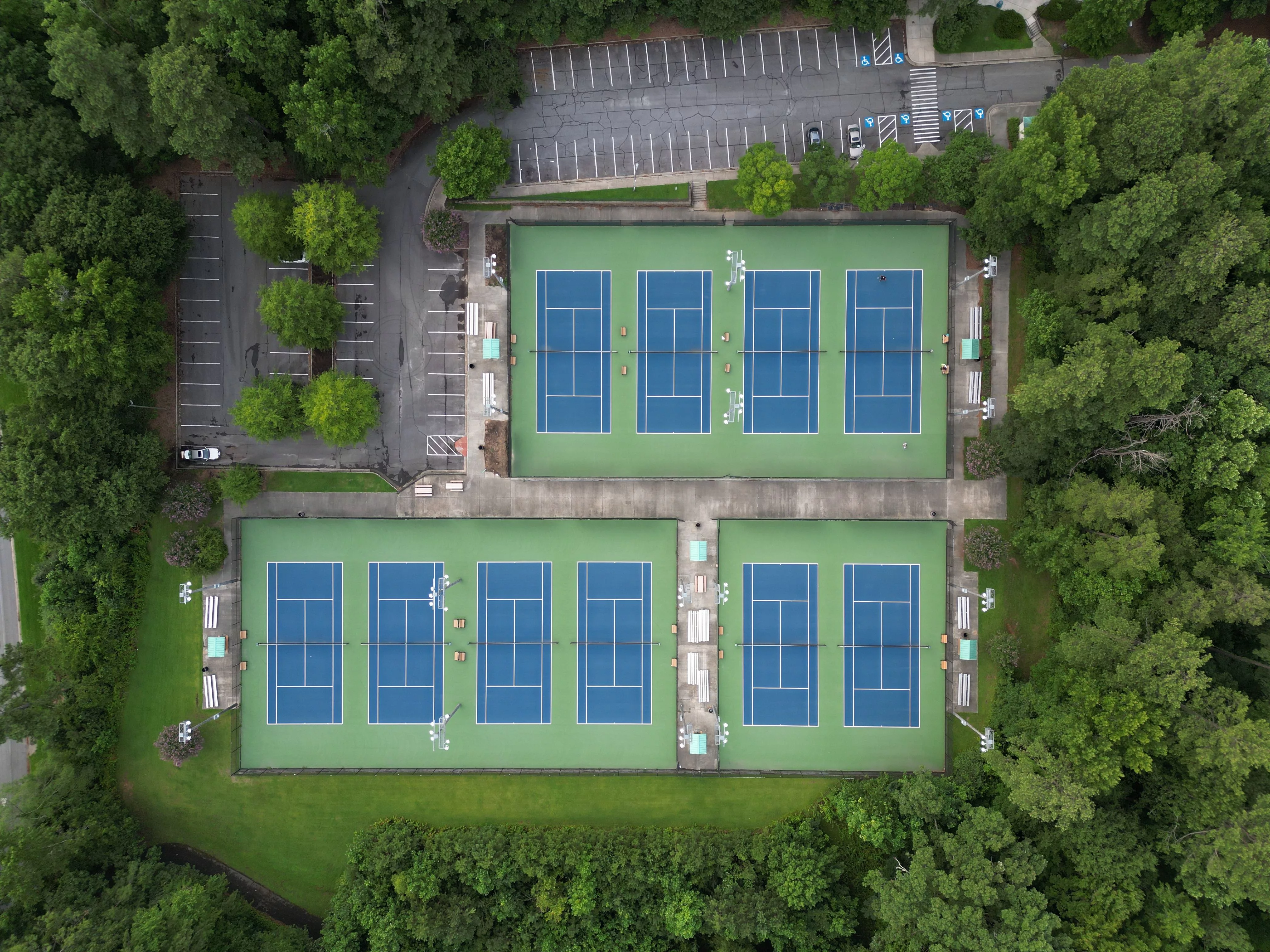 aerial-shot-of-the-tennis-courts-and-dense-trees
