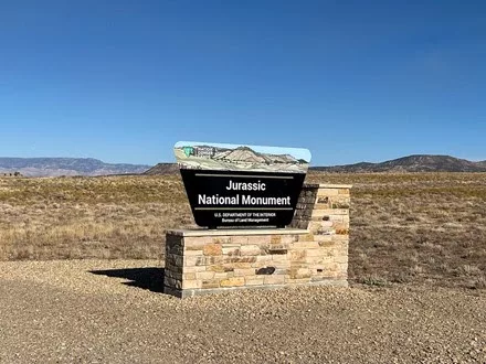 Photo of the Jurassic National Monument sign at the site.