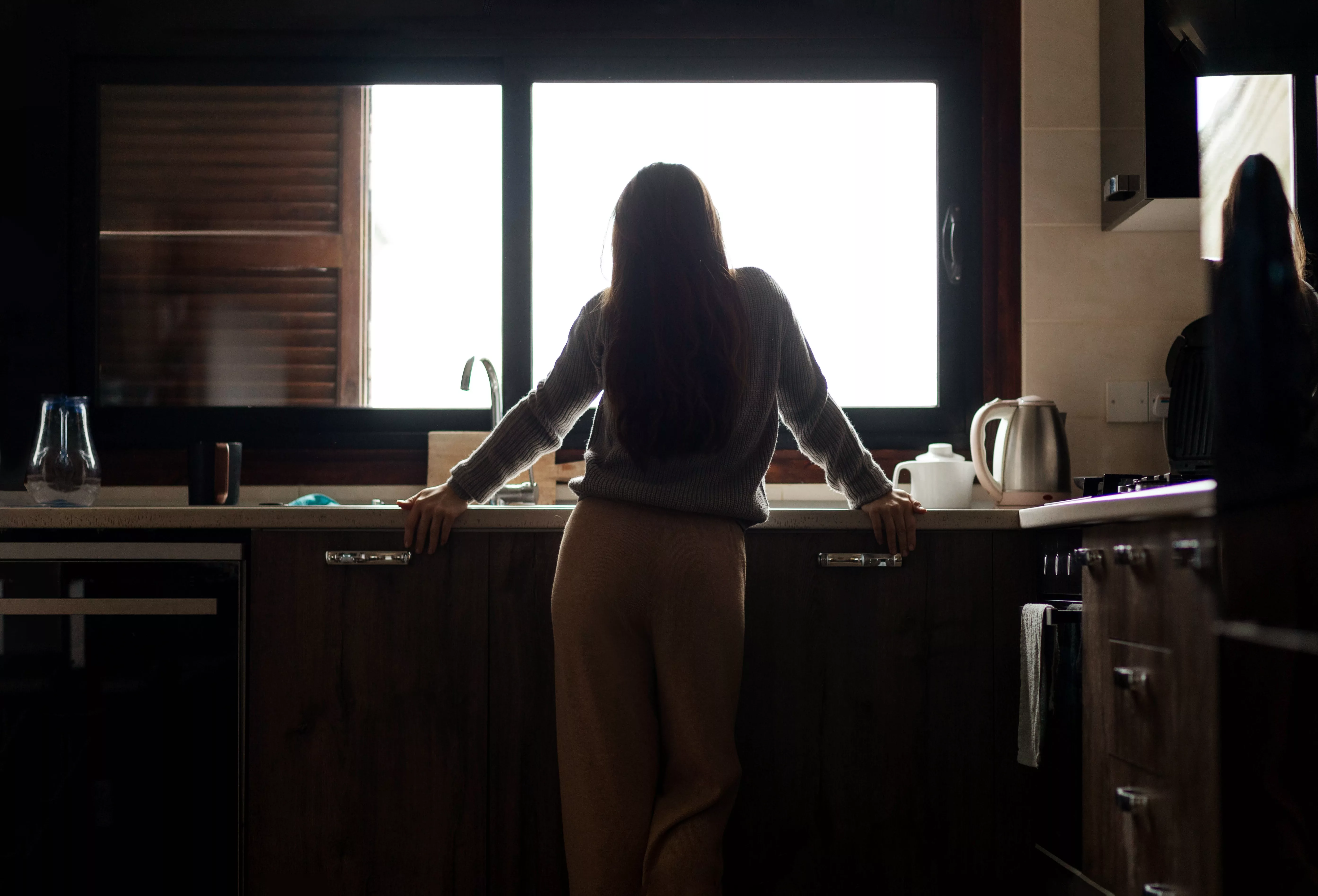 sad-brunette-woman-thinking-about-problems-in-the-kitchen-concept-of-depression-and-problems-selective-focus-and-abstraction