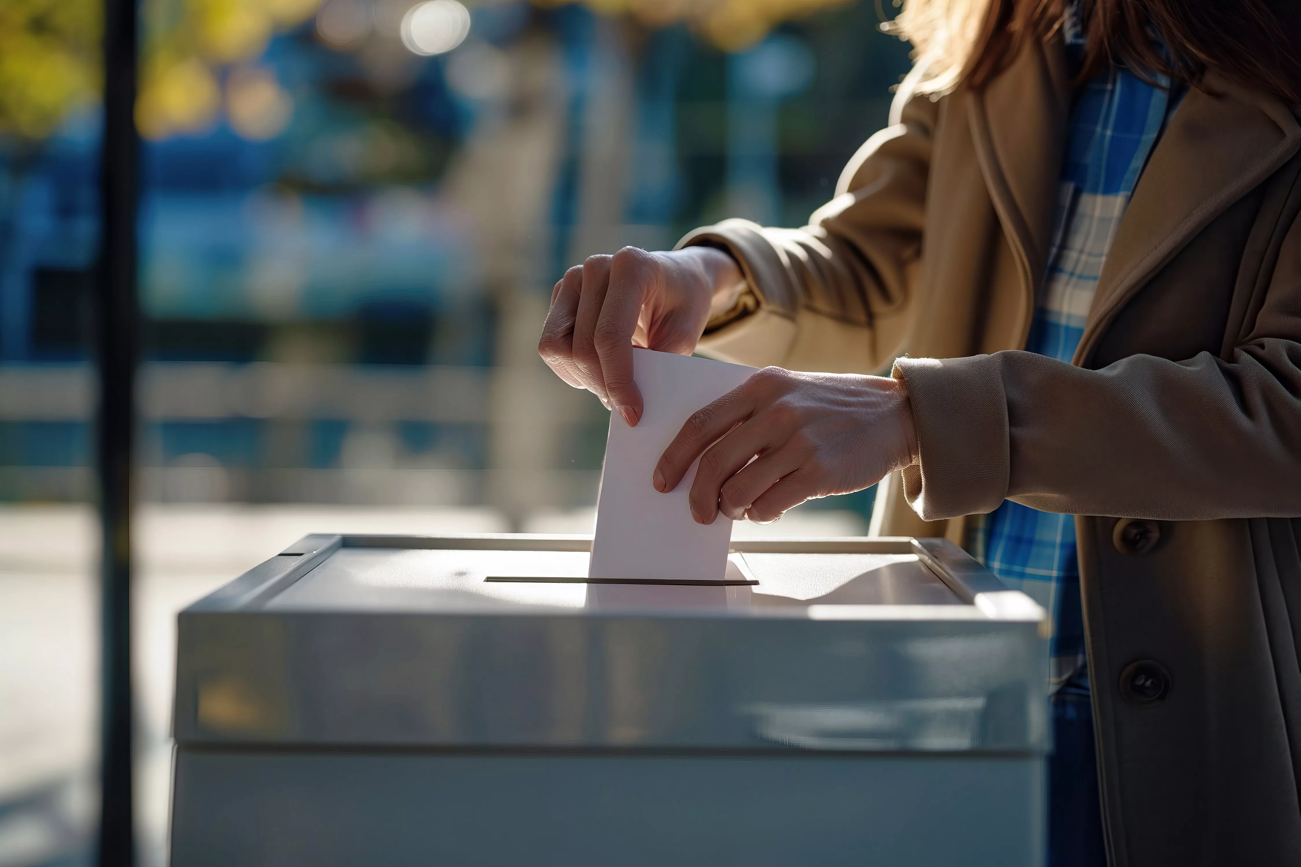 woman-depositing-voting-ballot-into-ballot-box-at-polling-station