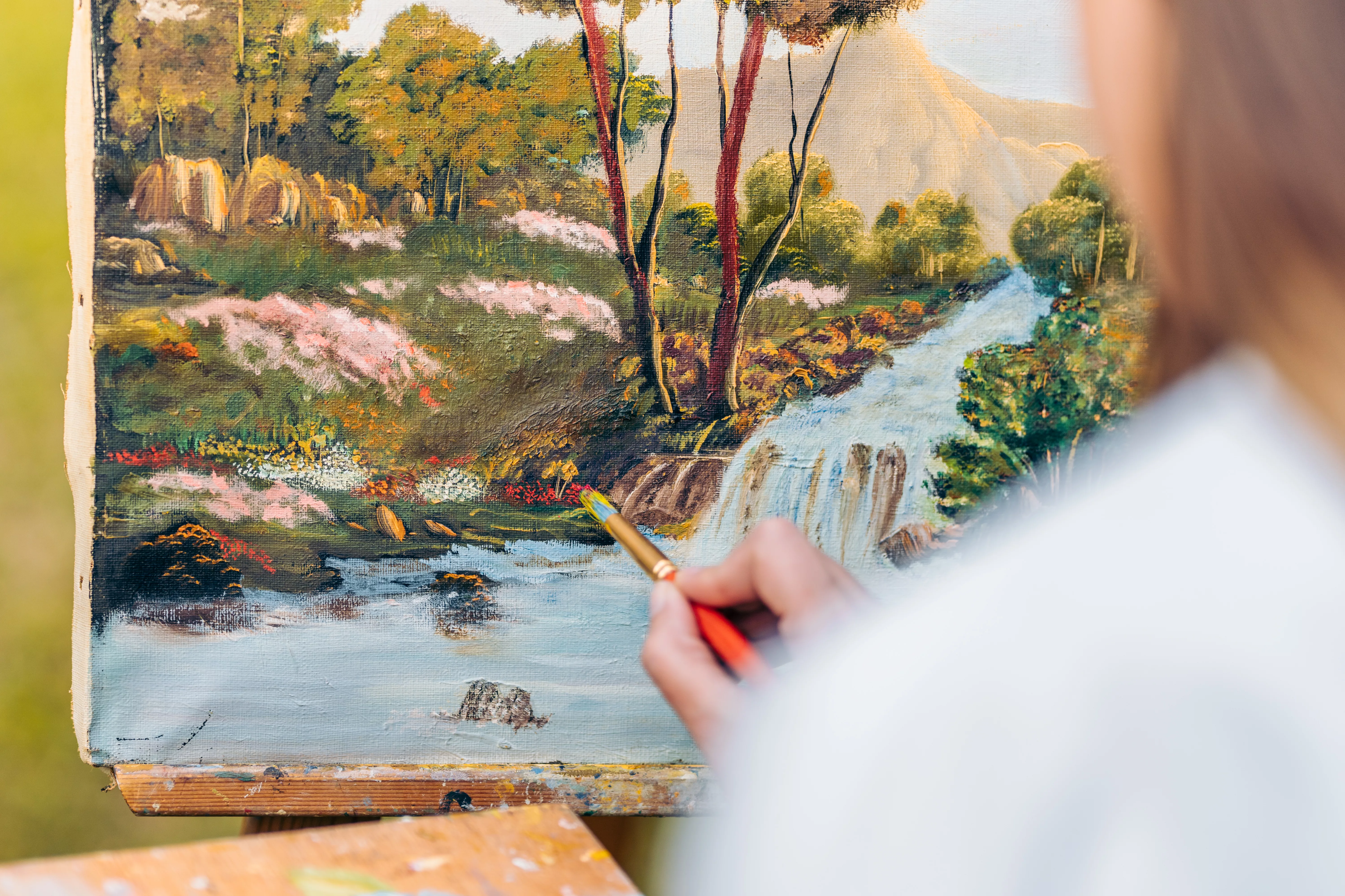 hand-painting-with-a-brush-on-a-canvas-with-a-painting-of-a-forest-2