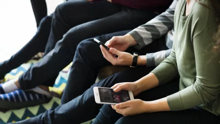 group-of-people-using-mobile-phone-on-couch