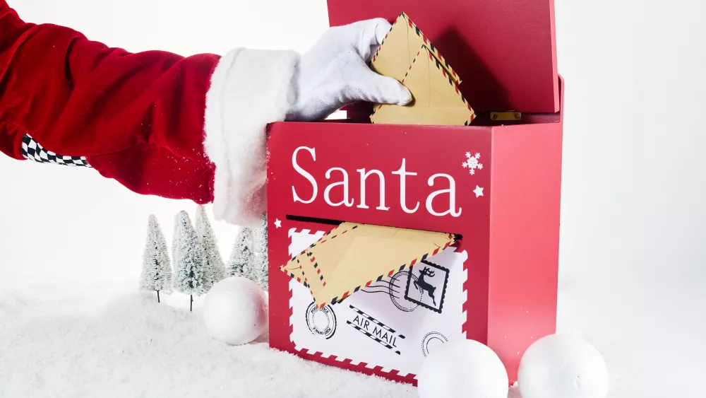 santa-claus-opening-his-mailbox-stuffed-with-letters