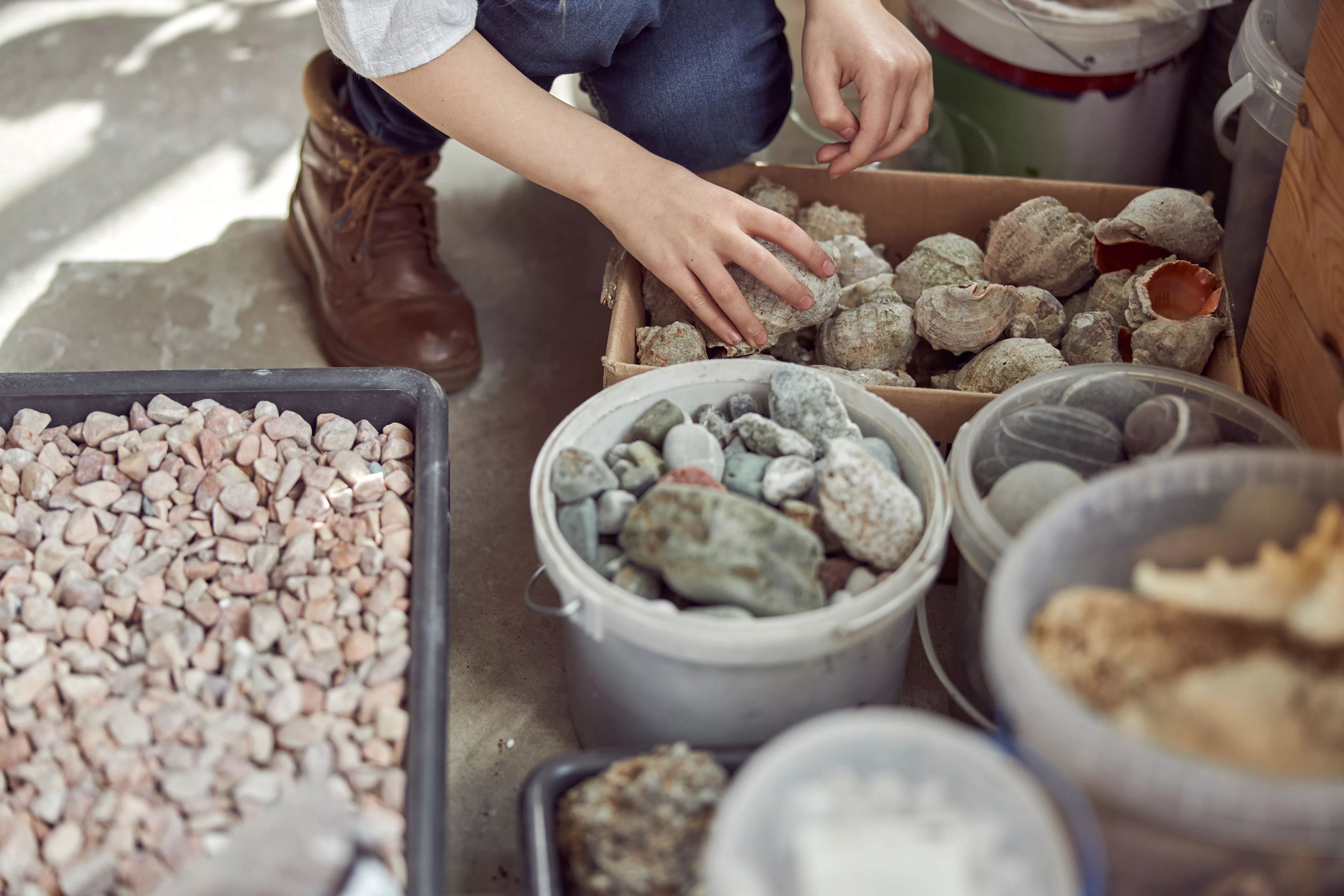 hands-of-young-caucasian-girl-who-is-working-to-do-a-composition-flourist-shop-with-different-kinds-of-dryed-flowers