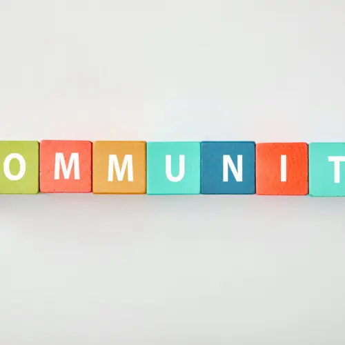 top-view-of-community-lettering-made-of-multicolored-cubes-on-grey-background-3
