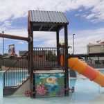 Helper cuts the ribbon to celebrate new improvements to city pool