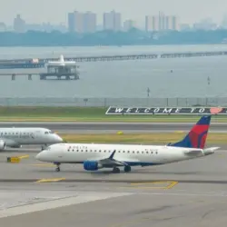 : Delta Airlines and American Eagle planes seen at the runway of LaGuardia International Airport. Manhattan^ New York^ USA - August 5^ 2025