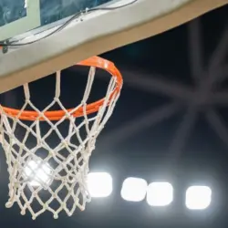 Basketball hoop hanging in a sports stadium waiting for the ball