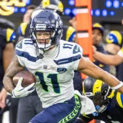 Seattle Seahawks wide receiver Jaxon Smith-Njigba (11) escapes a tackle-attempt by Los Angeles Rams cornerback Emmanuel Forbes Jr. (1) during an NFL football game Nov. 16^ 2025^ in Inglewood^ Calif.