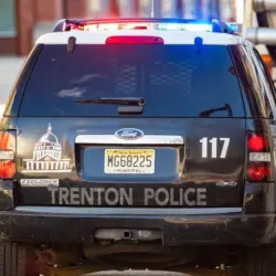 Municipal police car with flashing lights on the road at day Trenton^ NJ^ USA - Jan. 18^ 2021
