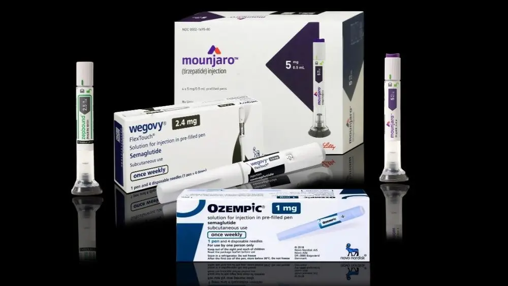 shutterstock_2459298149-1763234 Injection pens and packaging boxes of weight-loss and type 2 diabetes medication Mounjaro^ Wegovy^ Ozempic^ Zepbound Isolated on black background with reflections.