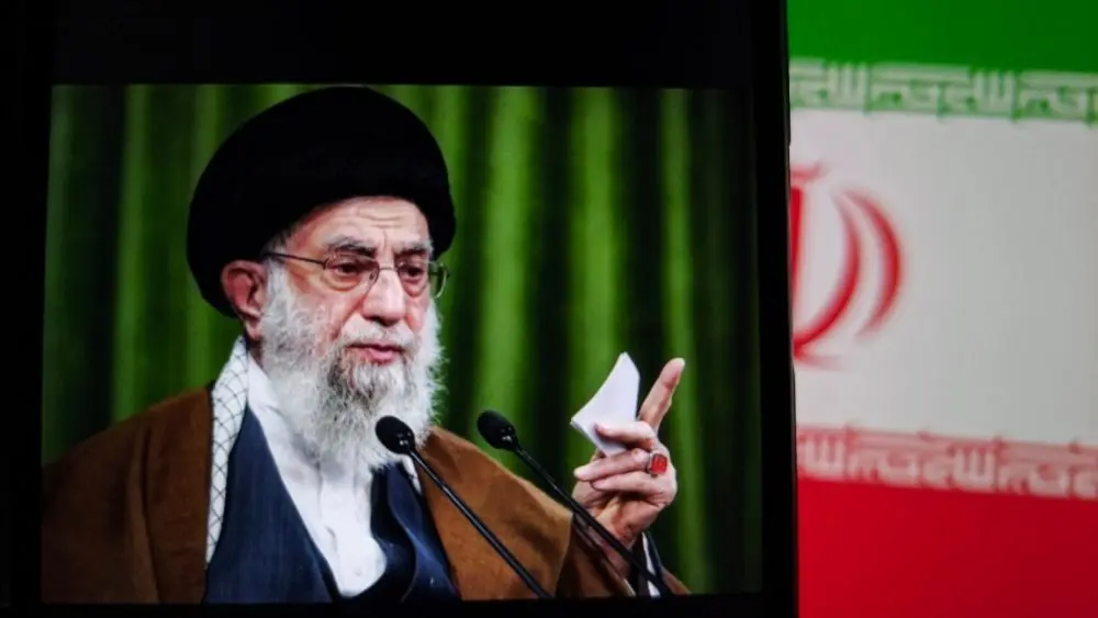 shutterstock_2683054177-1981558 This image captures Iranian Supreme Leader Ali Khamenei giving a speech^ with the Iranian flag prominently displayed.
