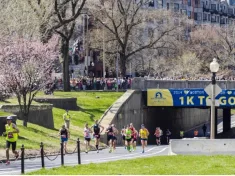Runners in the Boston Marathon pass the 1 kilometer to go line on their way to the finish line
