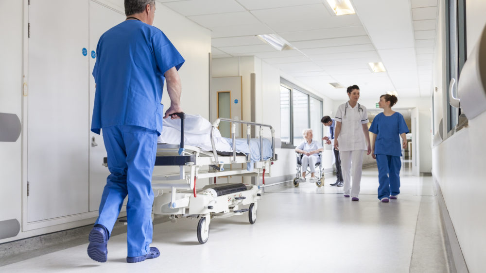 doctors-hospital-corridor-nurse-pushing-gurney-stretcher-bed