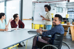 portrait-of-smiling-disabled-business-executive-in-wheelchair-at-meeting