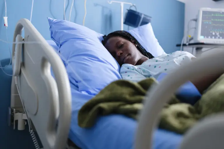 Black female patient sleeping in quiet hospital stock photo