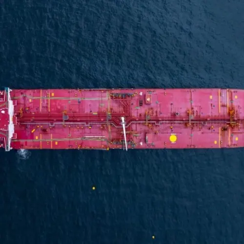 Aerial view crude oil tanker ship at sea^ Red crude oil tanker ship top view^ Logistic and maritime transpoprtation of petroleum^ Modern offshore terminal loading tanker ship.