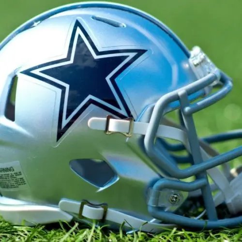 NFL Dallas Cowboys helmet on artificial grass playing turf ^ product shot