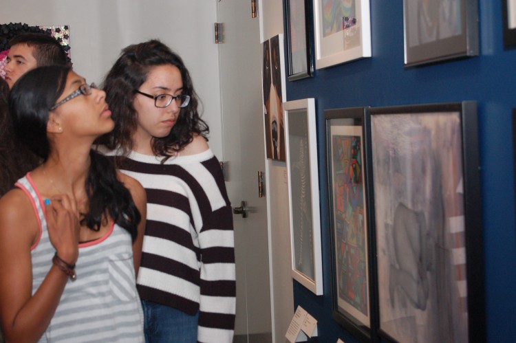 Students review the art selected for the 2014 iCreate exhibition at the Bruce.