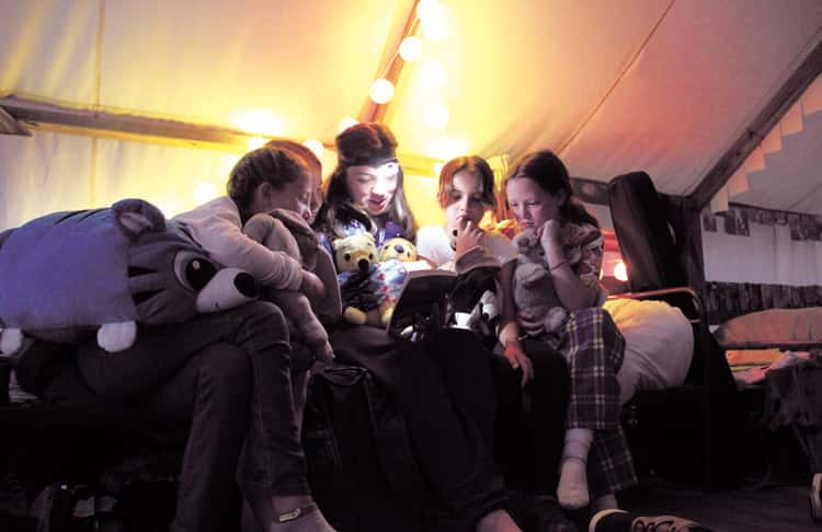 girls-reading-inside-tent
