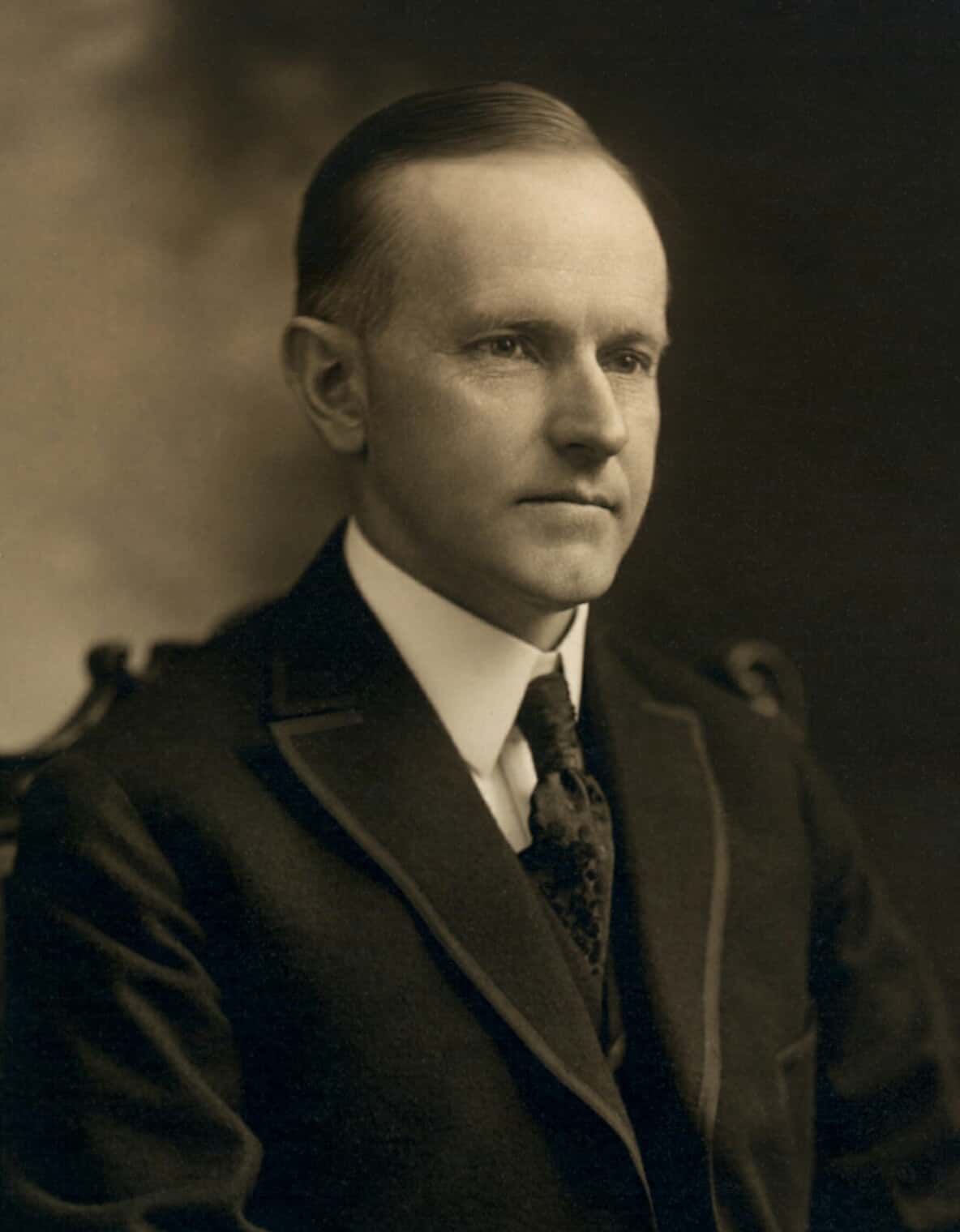 calvin_coolidge_bw_head_and_shoulders_photo_portrait_seated_1919