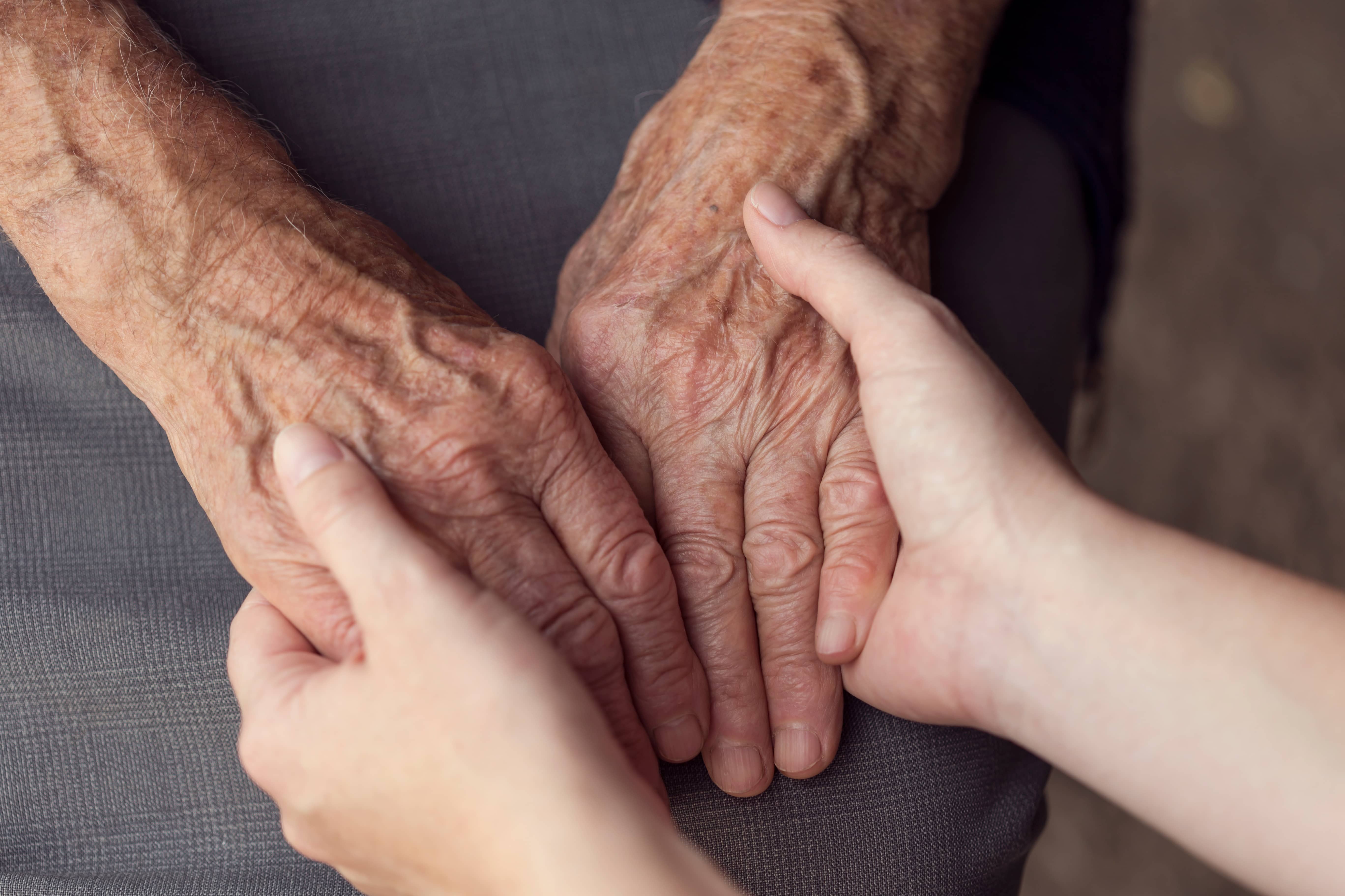 oldandyoungpersonholdinghands-elderlycareandrespect