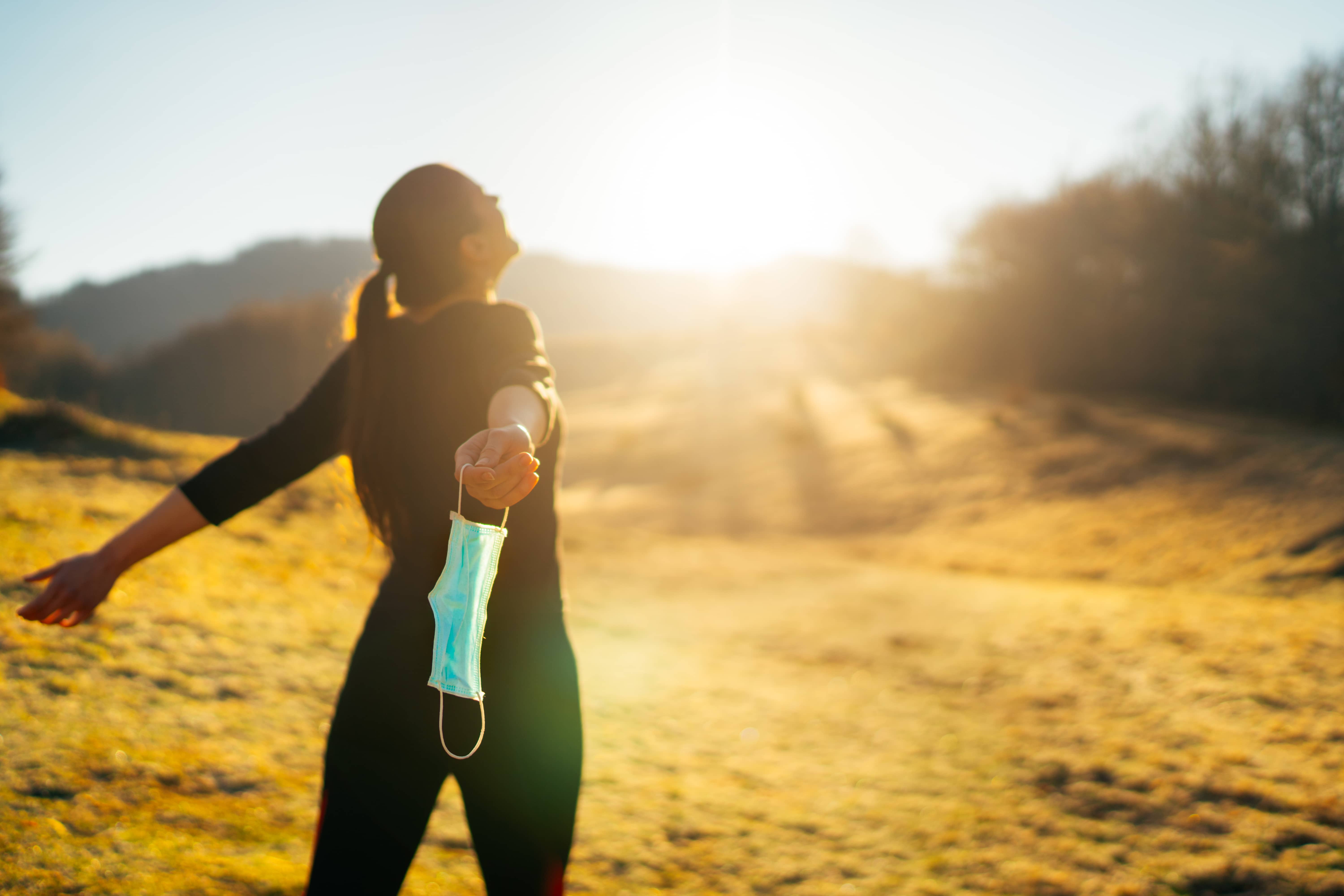 womancelebratingwithoutmask-conceptofdefeatingillness-recoveredfromcoronavirus-cureddisease
