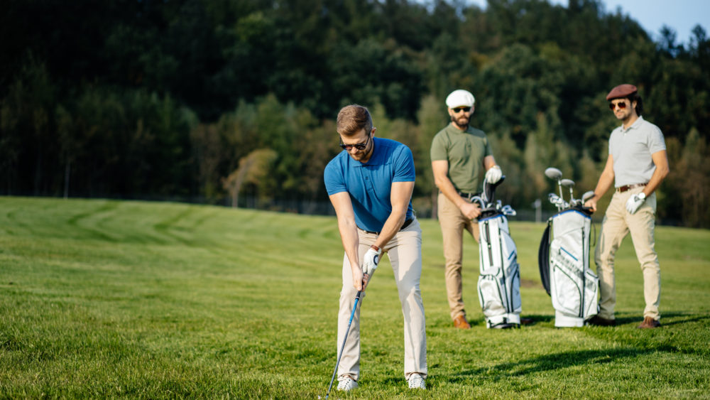 stylishmulticulturalfriendsspendingtimetogetherwhileplayinggolfon