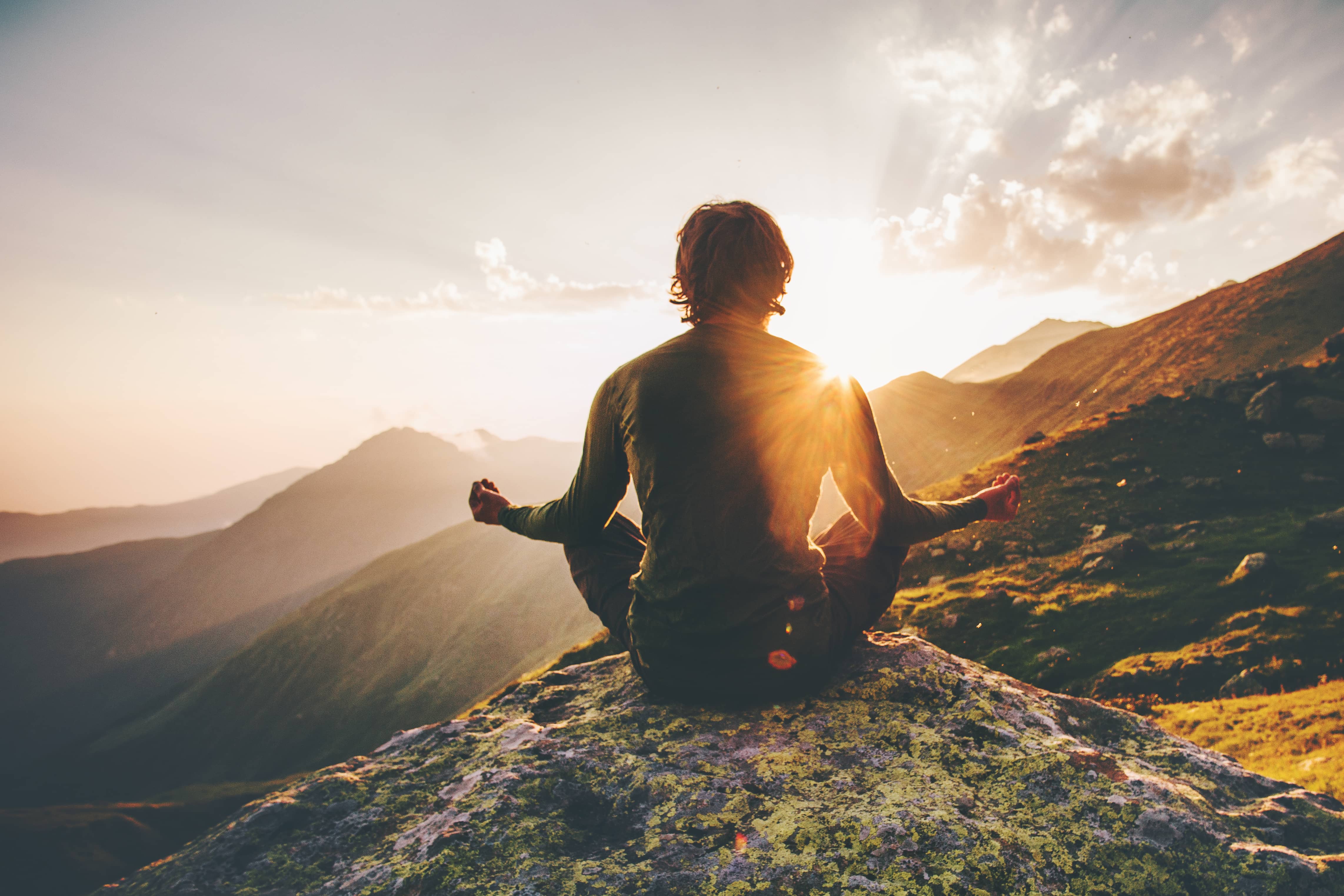 manmeditatingyogaatsunsetmountainstravellifestylerelaxationemotional