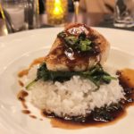 Salmon Atop Spinach and Rice Served with Black Bean Sauce