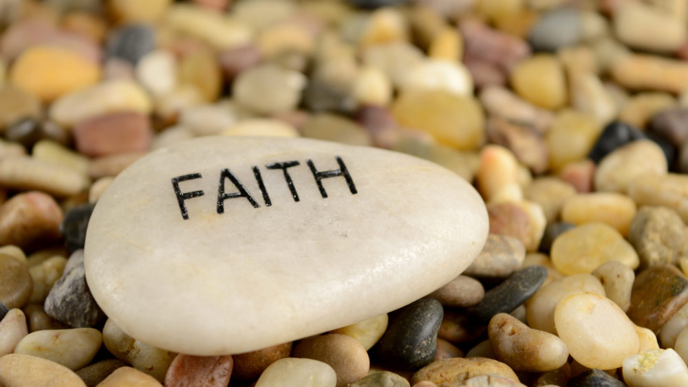 asmoothriverstoneisetchedwiththewordfaith